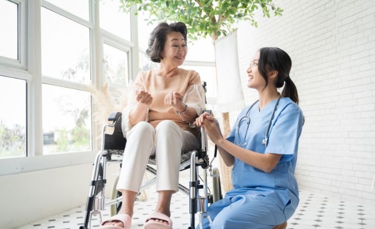 Align Care community nurse providing personalised care and support to an elderly woman in a wheelchair.