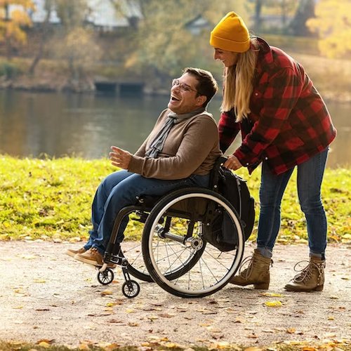 Align Care disability support worker assisting a man using a wheelchair during a community outing