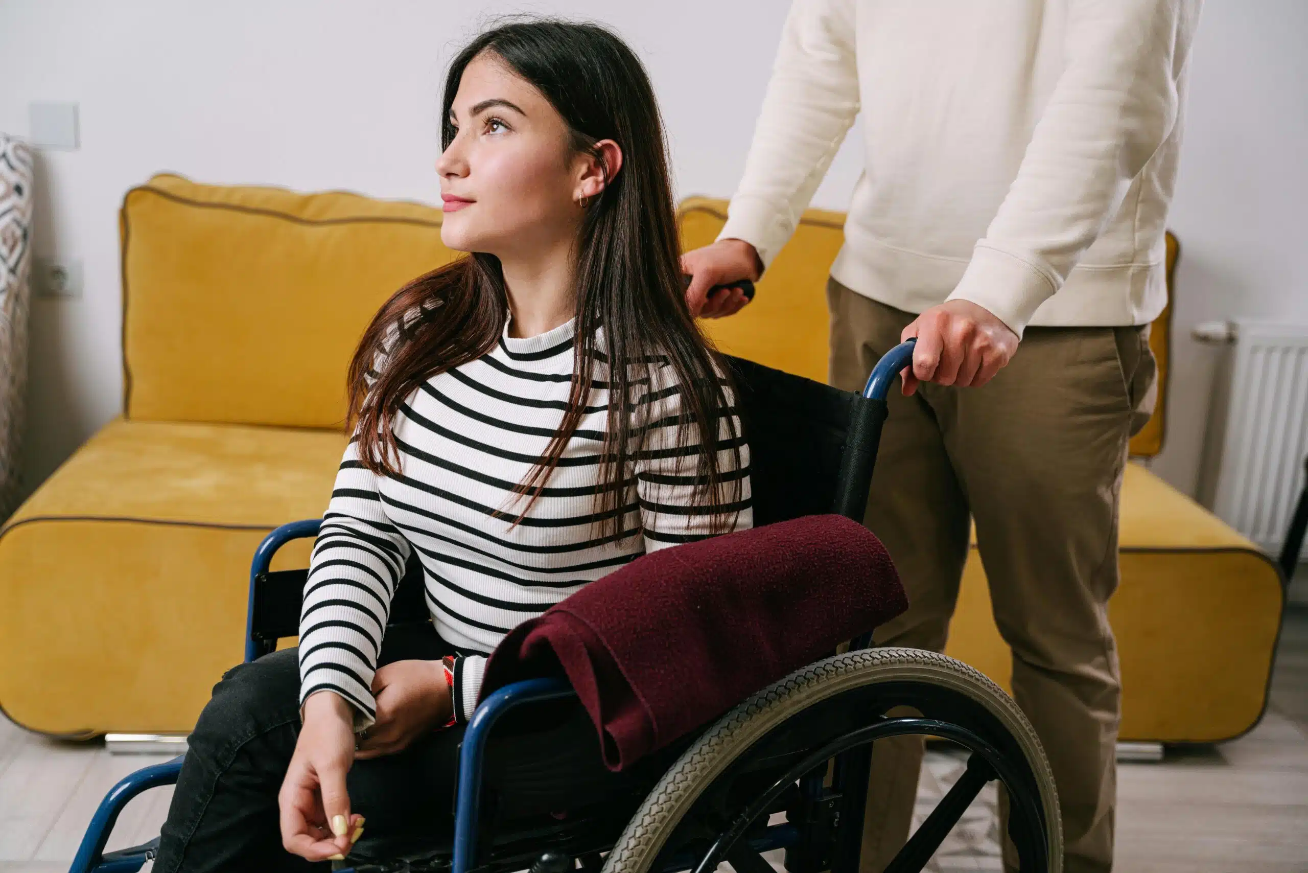 Align Care personal care support worker assisting a woman using a wheelchair at home.